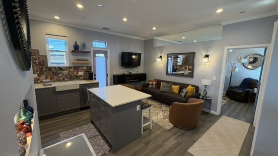 Completed ADU interior with kitchen, island seating and living area, finished by Elusive Construction after another contractor left the build unfinished