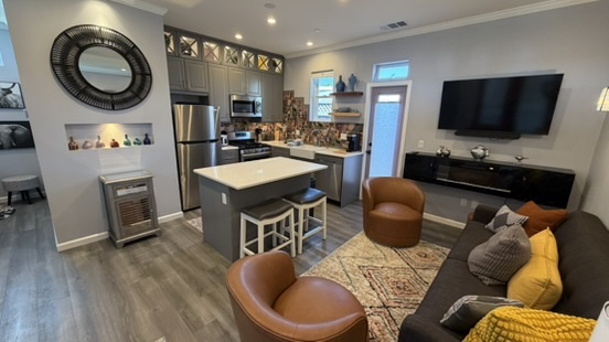 ADU kitchen and living space showing refrigerator, range and cabinetry