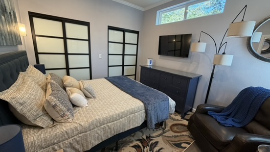 ADU bedroom showing built-in closets with sliding doors