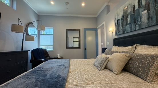 Completed ADU bedroom with window, dresser and full-size bed