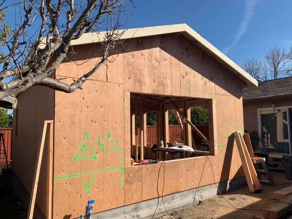 ADU shell with roof framed and window openings cut in