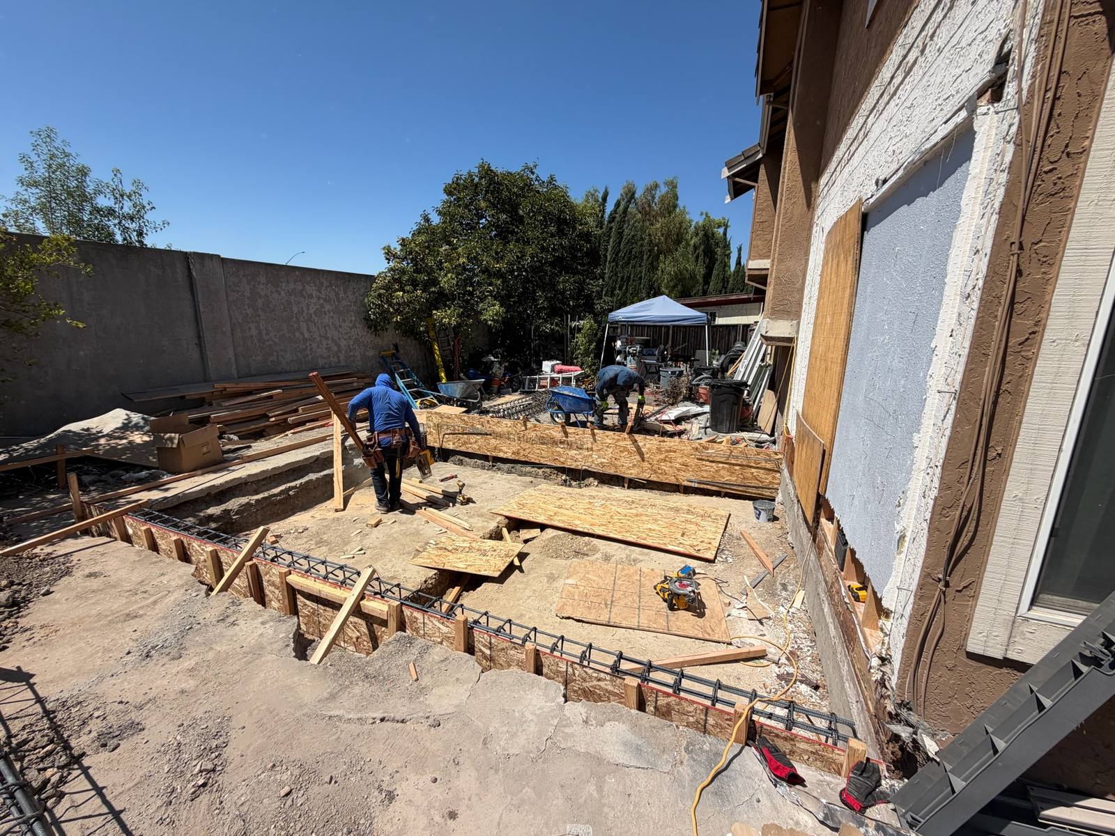 Elusive Construction crew setting foundation forms and rebar for a home addition in Milpitas