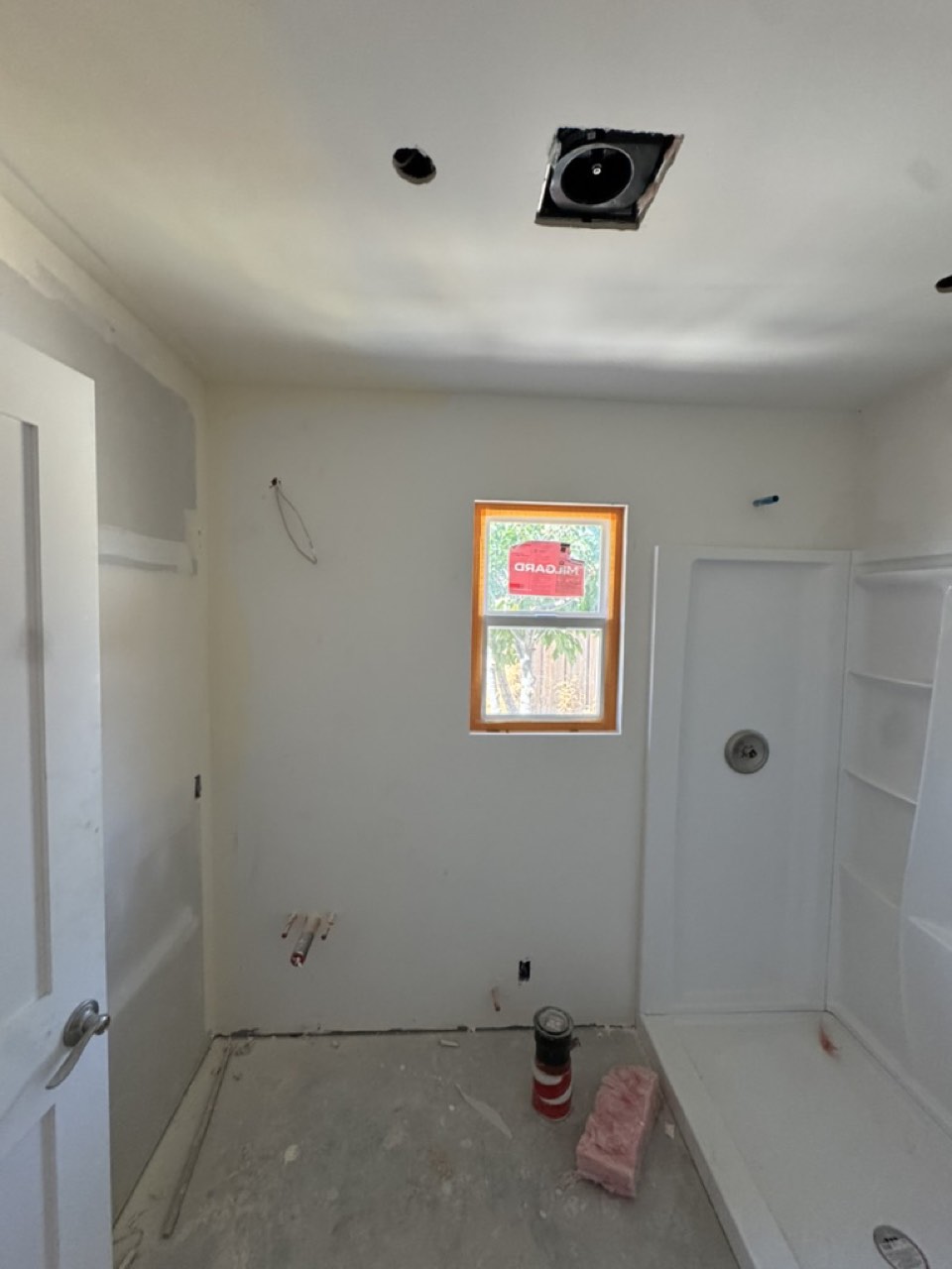 ADU bathroom at rough stage with shower pan set and drywall hung, San Jose