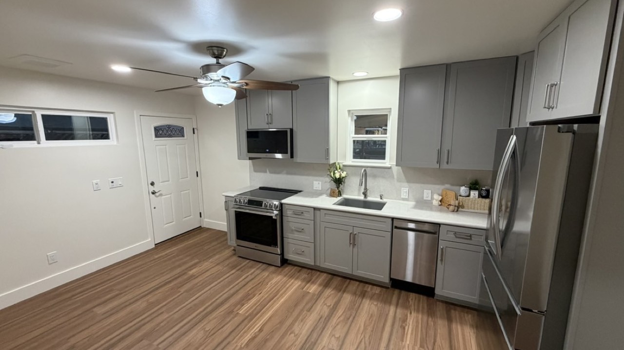 Completed ADU kitchen in San Jose with grey shaker cabinets, quartz counters and stainless appliances