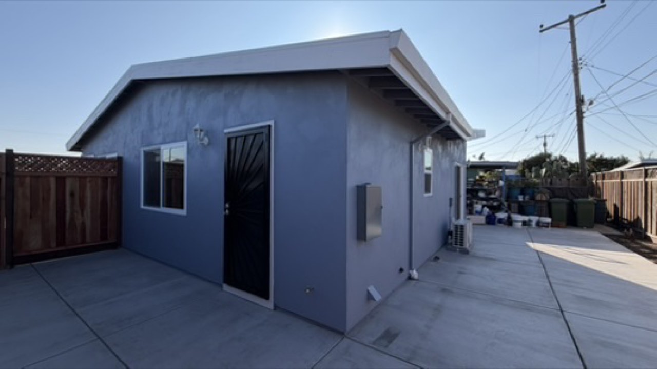 Completed attached ADU in San Jose with grey stucco exterior, converted from an attached garage by Elusive Construction