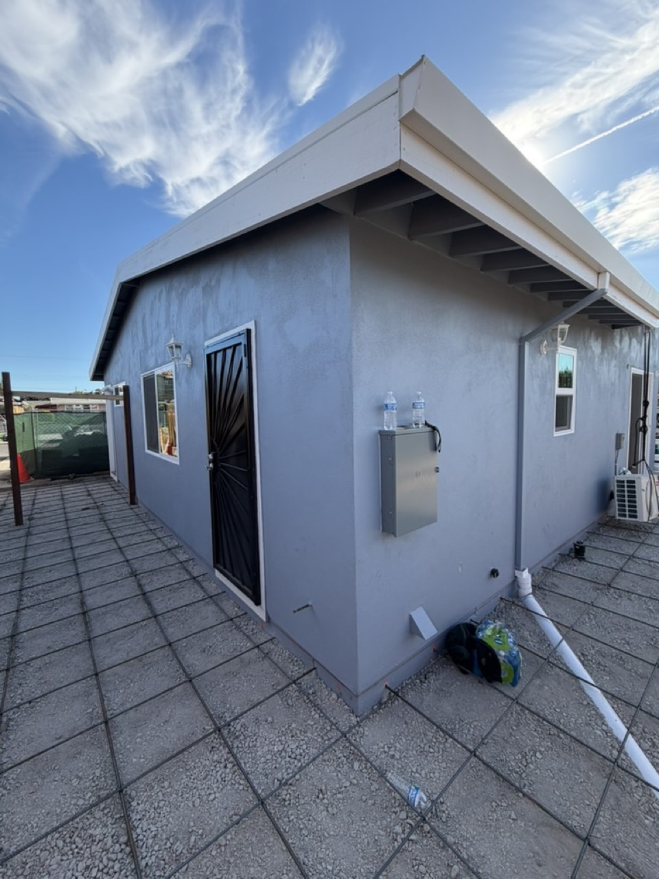Exterior of a completed San Jose ADU with electrical panel and patio slab prepared for pour