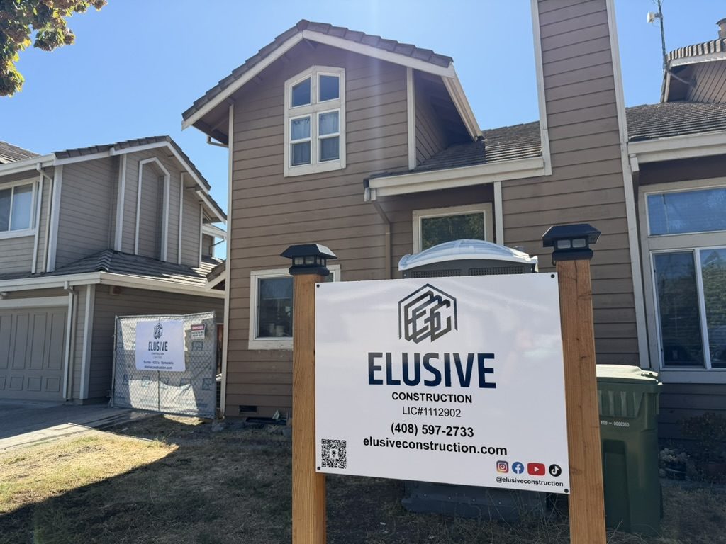 Elusive Construction jobsite sign with license number and phone in front of a home under construction in San Jose