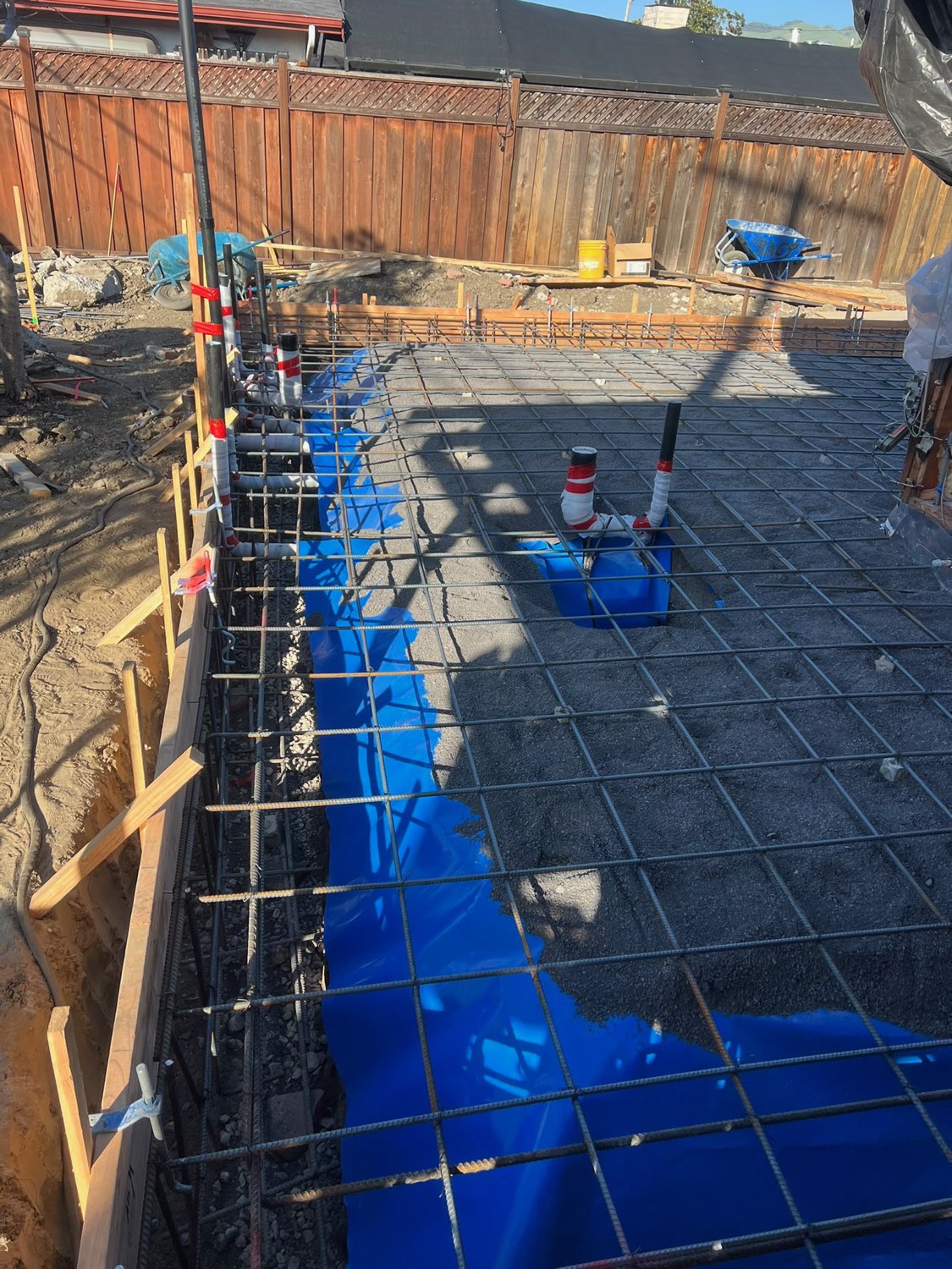New foundation for a room addition in Milpitas — rebar mat and vapor barrier over a compacted engineered pad