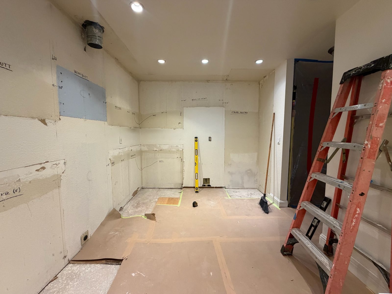 Kitchen walls marked with cabinet sizes and positions before installation