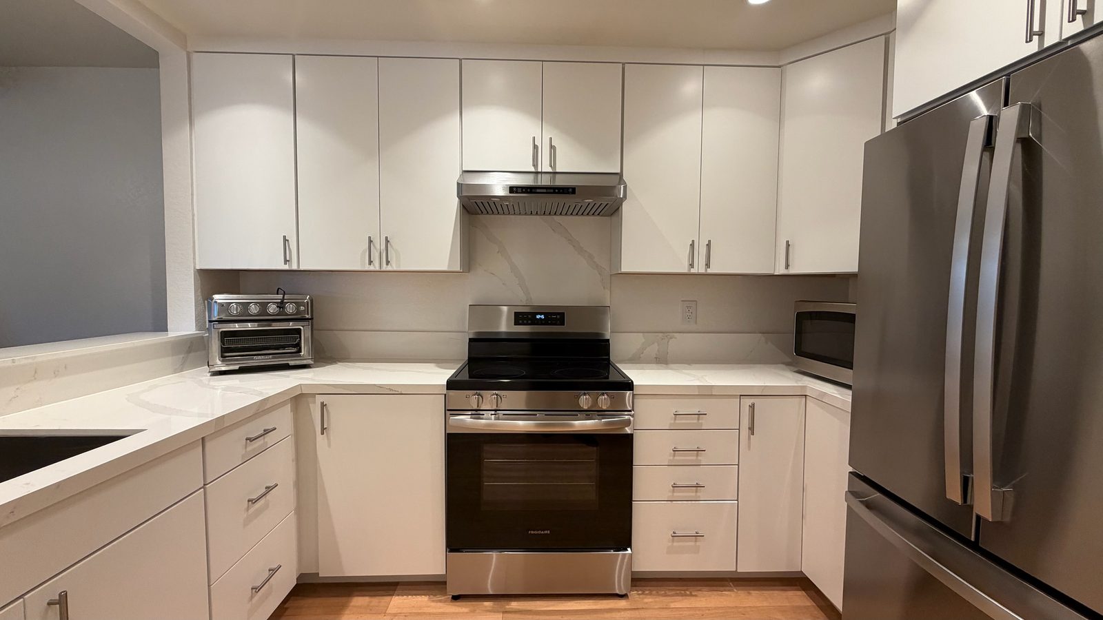 Finished kitchen from the peninsula, with the undermount sink and new counters in the foreground