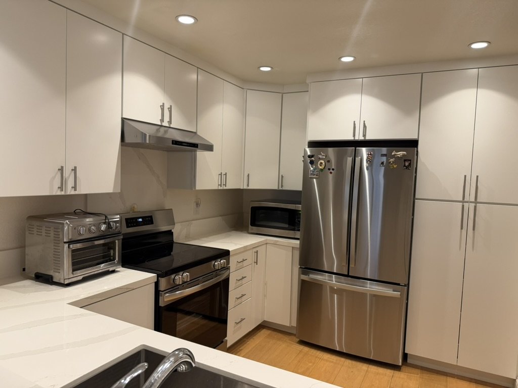 Corner run and full-height pantry cabinets of the finished kitchen in use