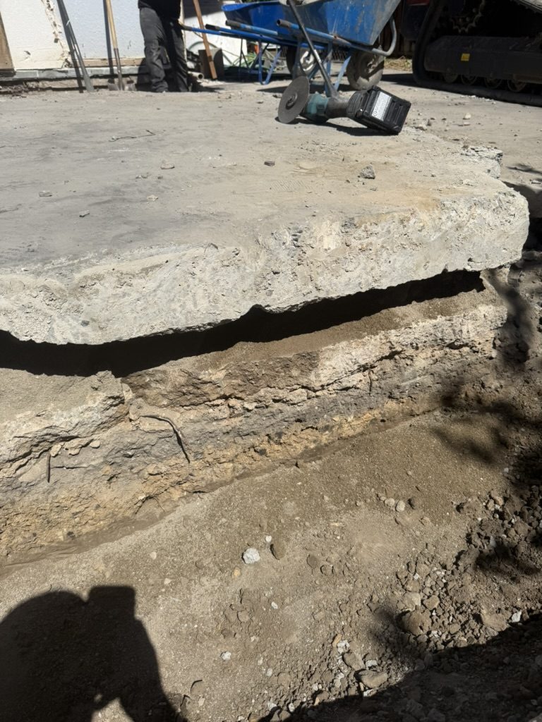 Cut edge of the slab showing a second older slab beneath it with a gap between the two
